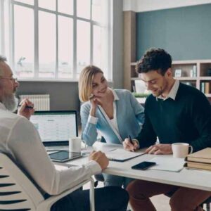 Smiling Couple signing an approved loan form