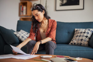 women reading banking paperwork at home