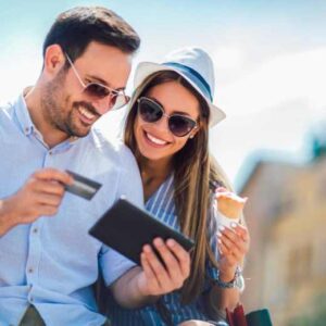 couple smiling and holding a credit card