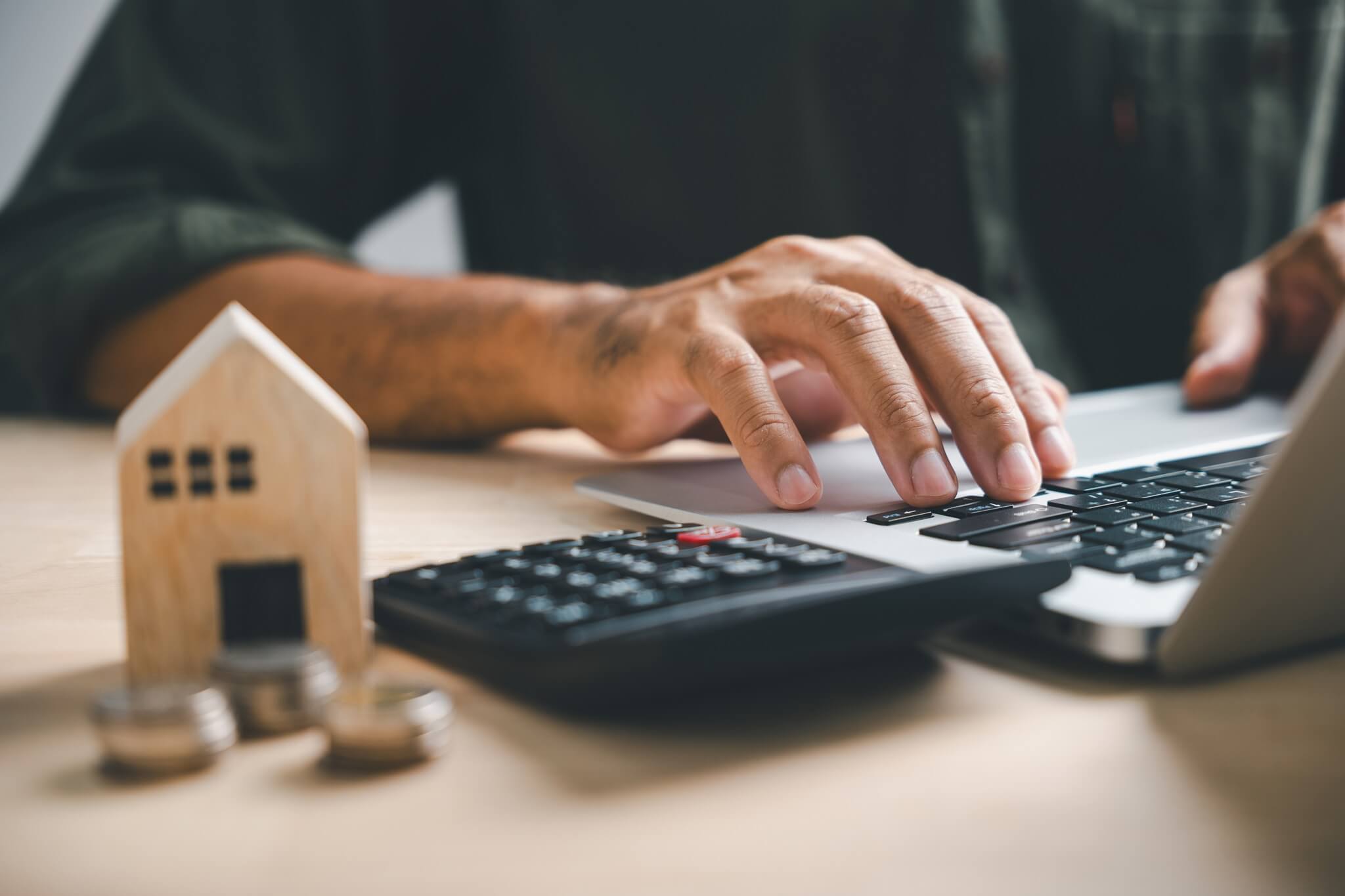 hand presses calculators pondering home refinance