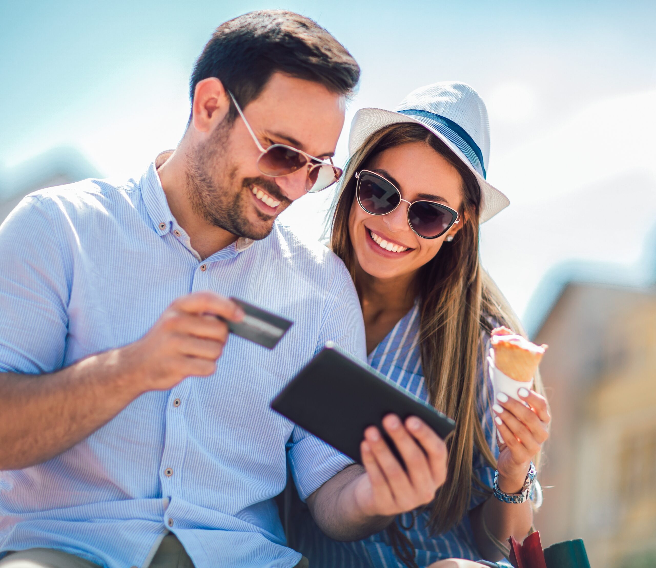 happy couple traveling using their credit card