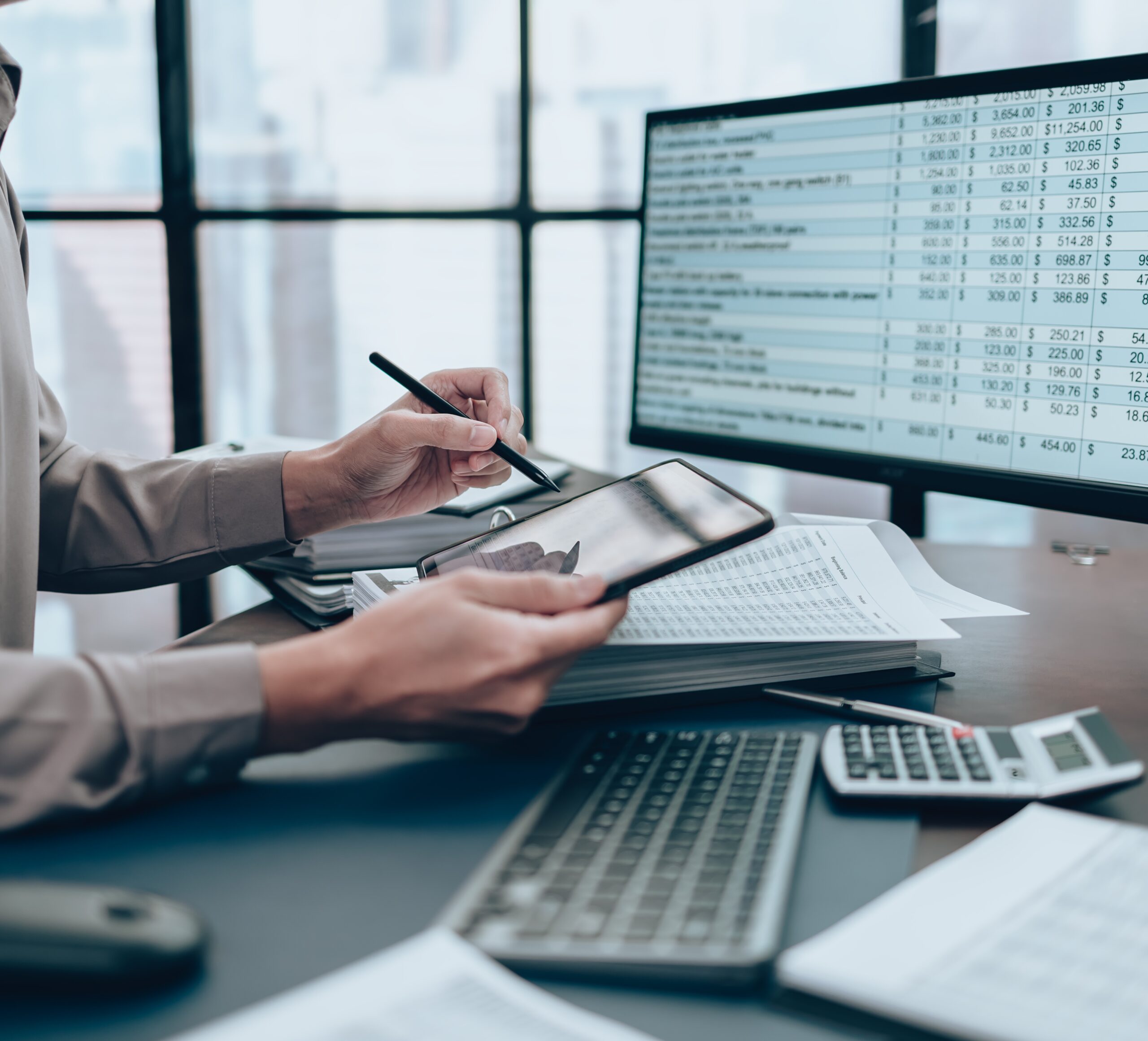 man reviewing account information holding a tablet and pen