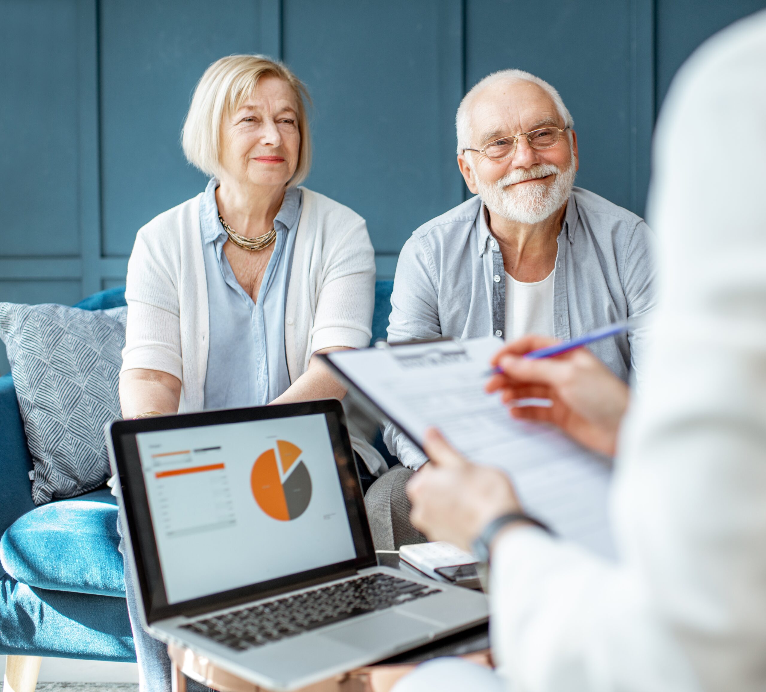 retired couple smiling at an estate planning specialist