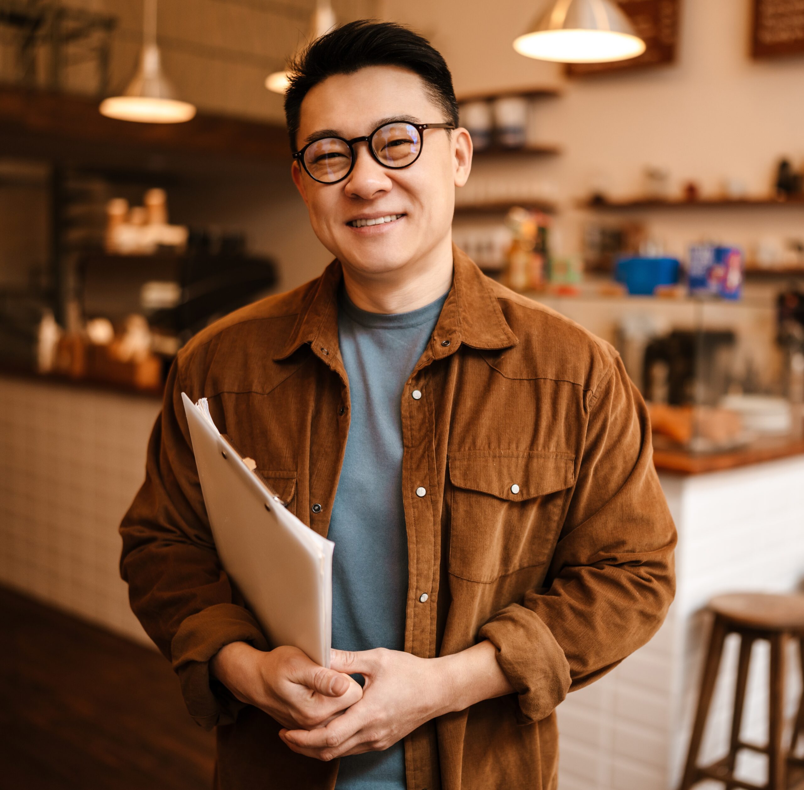 small business owner smiling holding paperwork
