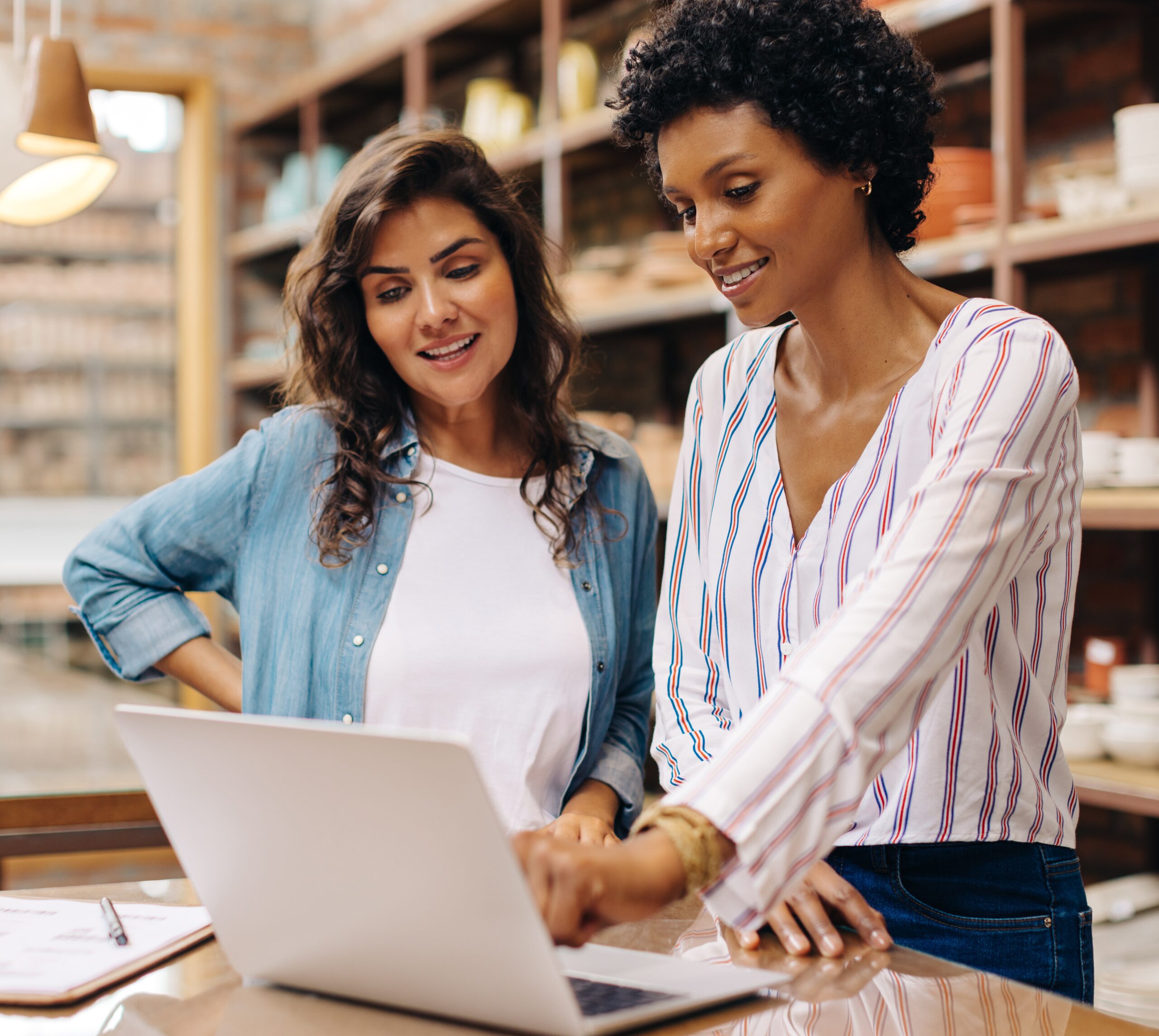 two business owners reviewing their banking account on a laptop