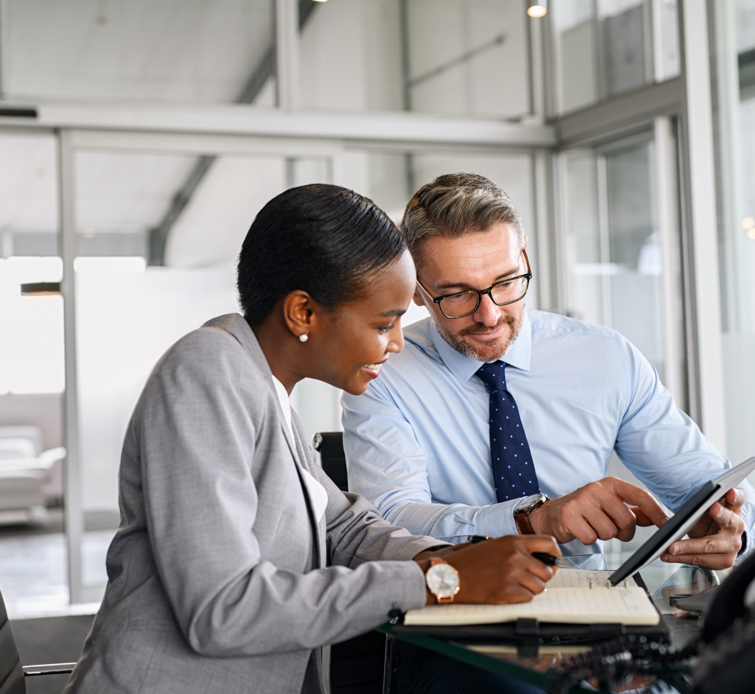 two lawyers reviewing account on tablet