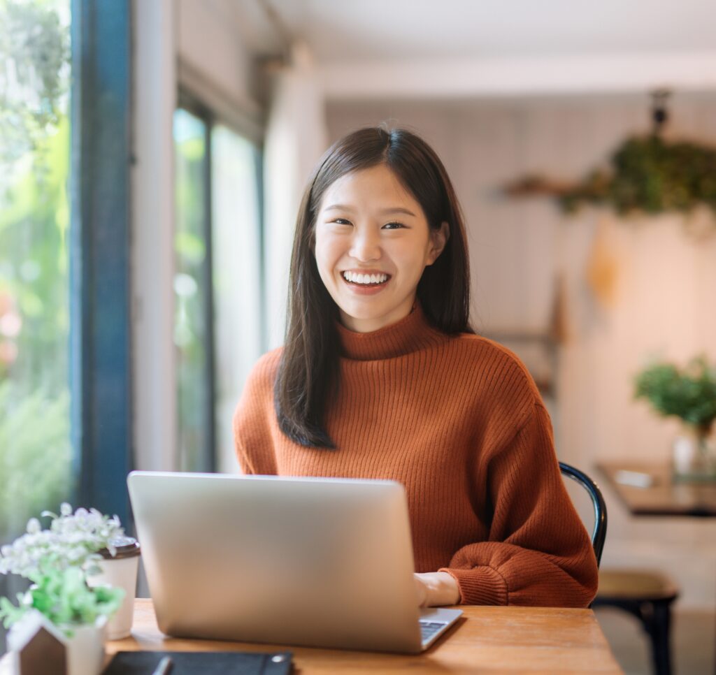 young women in an office space using a laptop