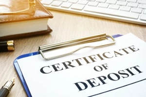 certificate of deposit and pen on a desk