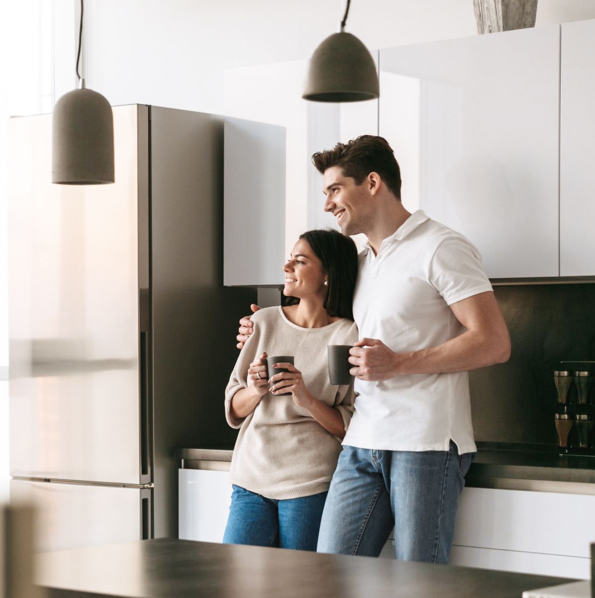 happy couple standing in new home after mortgage loan approval