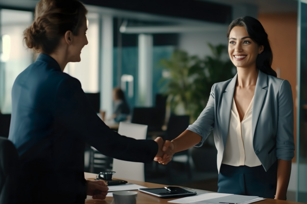 woman applying for banking job shakes hand with president