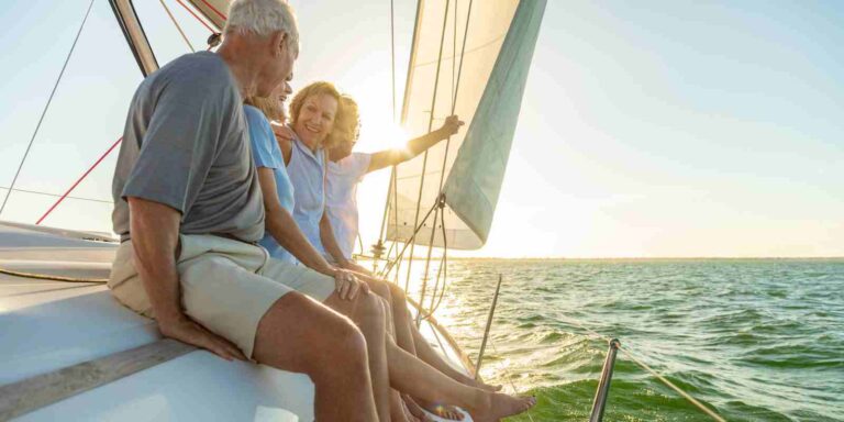 Retired man enjoying time with his family on a sailboat after estate planning